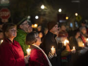 Attendees hold candles Friday, Dec. 21, 2023, during a Homeless Persons Memorial Day event at St. Paul Lutheran Church in downtown Vancouver.