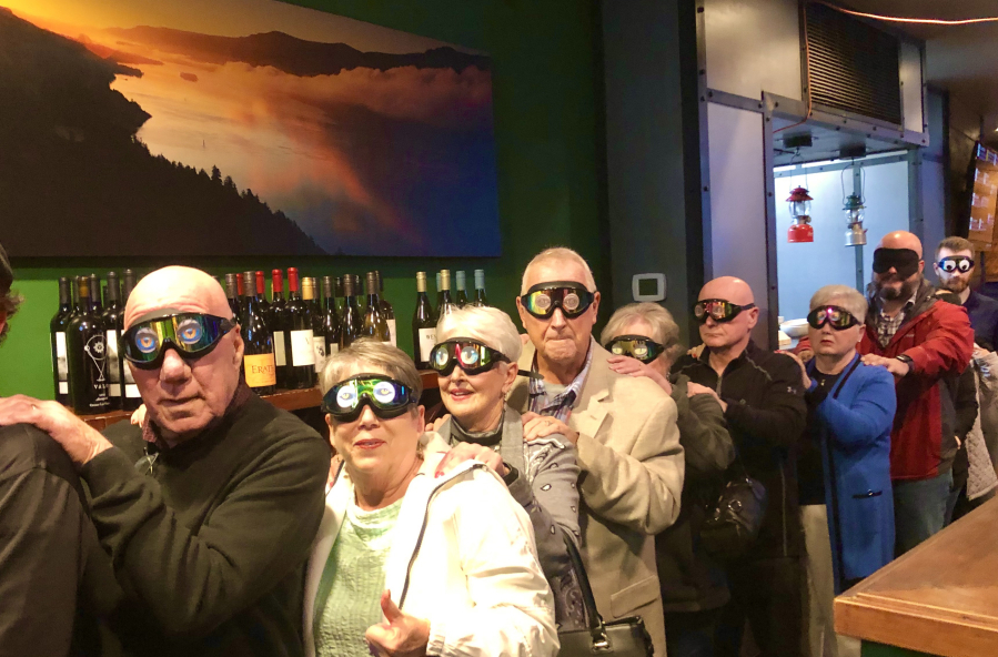 Diners in black-out glasses head into the Black Forest Dark Dining Experience at Wyld Pines in east Vancouver.