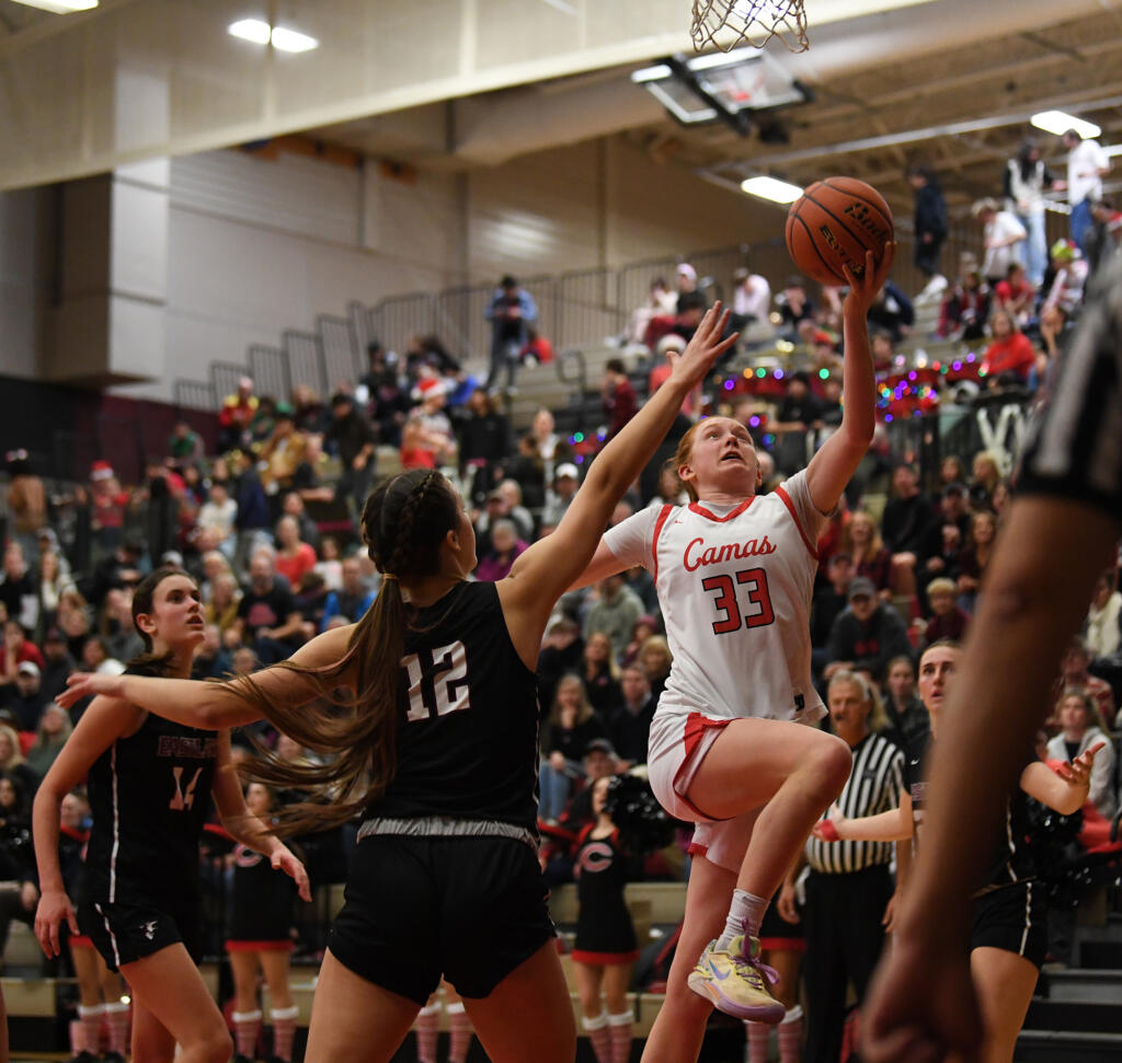 Camas senior Addison Harris, right, lays the ball into the basket Friday, Dec. 15, 2023, during the Papermakers’ 58-46 win against Eastlake at Camas High School.