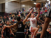 Camas senior Addison Harris, right, lays the ball into the basket Friday, Dec. 15, 2023, during the Papermakers’ 58-46 win against Eastlake at Camas High School.
