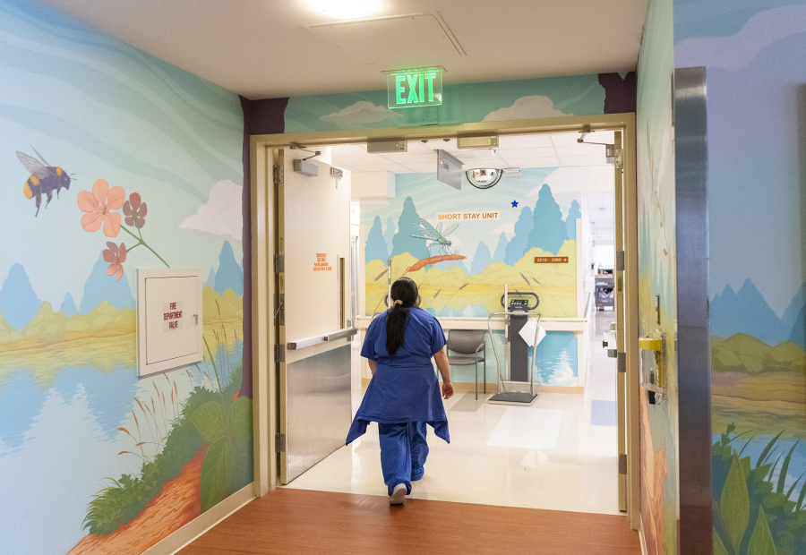 A nurse walks by a mural by Portland-based artist John Vance on Tuesday at Legacy Salmon Creek Medical Center.