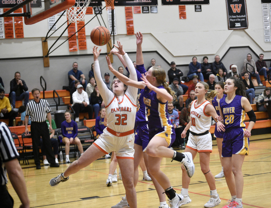 Washougal&rsquo;s Catherine Dewey (32) and Columbia River&rsquo;s Marley Myers battle for the ball as Washougal&rsquo;s Isabella Albaugh and River&rsquo;s Emma Iniguez look on during River&rsquo;s 68-47 win over Washougal at Washougal High School on Thursday, Dec. 21, 2023.