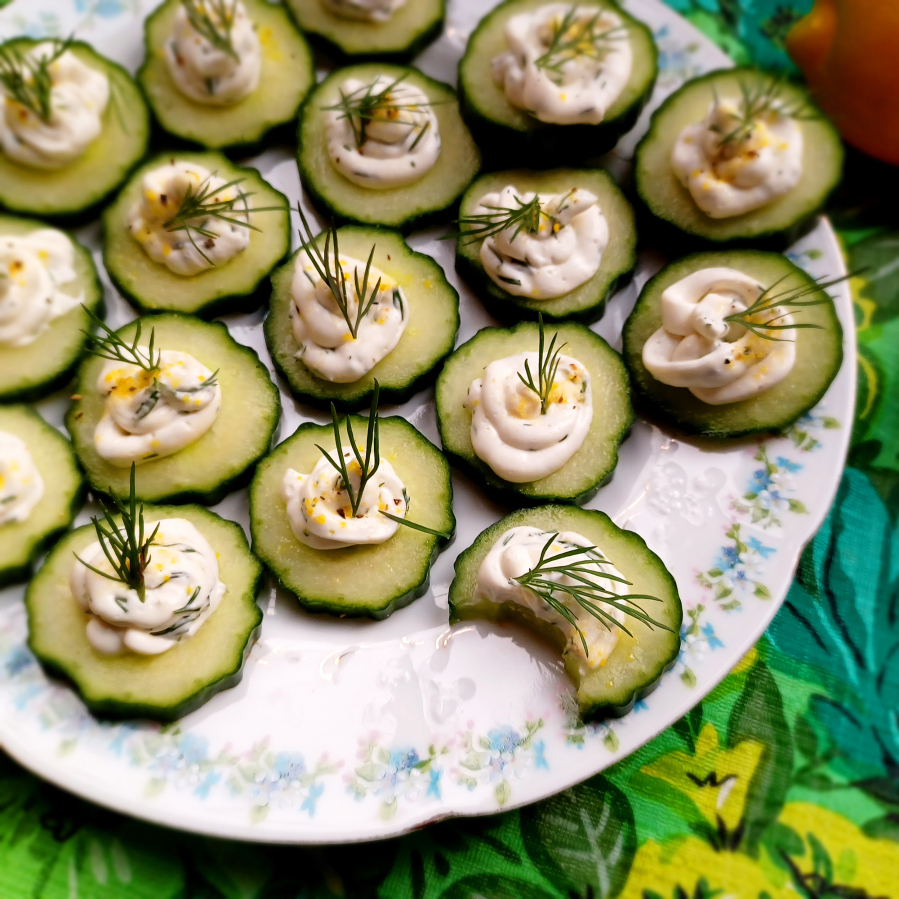 2024 is predicted to be the Year of the Snack. Make yourself a fancy snack with herbed cream cheese and cool cucumber slices.