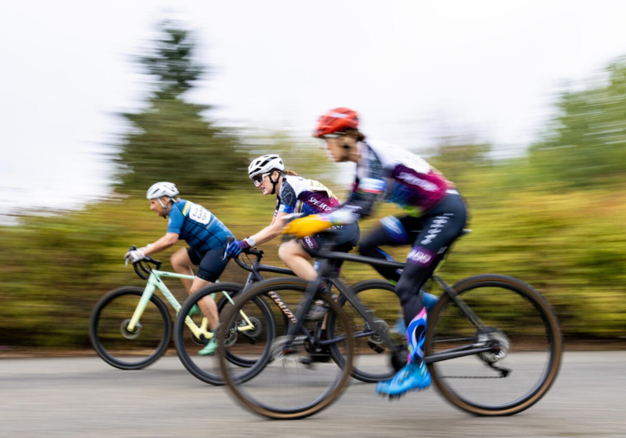 Three racers in the female 40+ heat zoom by during their cyclocross heat in October at Magnuson Park in Seattle.