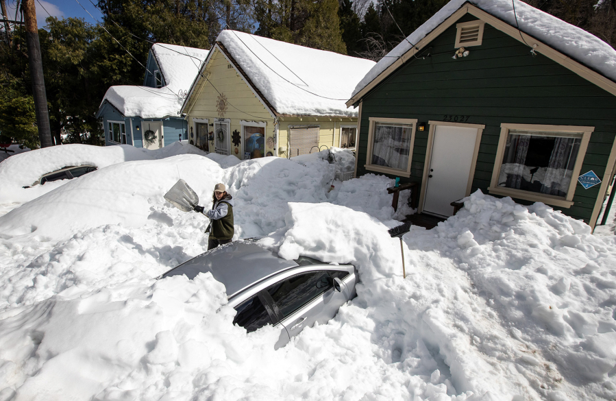 Kadyn Wheat shovels snow in early March as he works to free the family car, entombed after successive snowstorms in the San Bernardino Mountains.