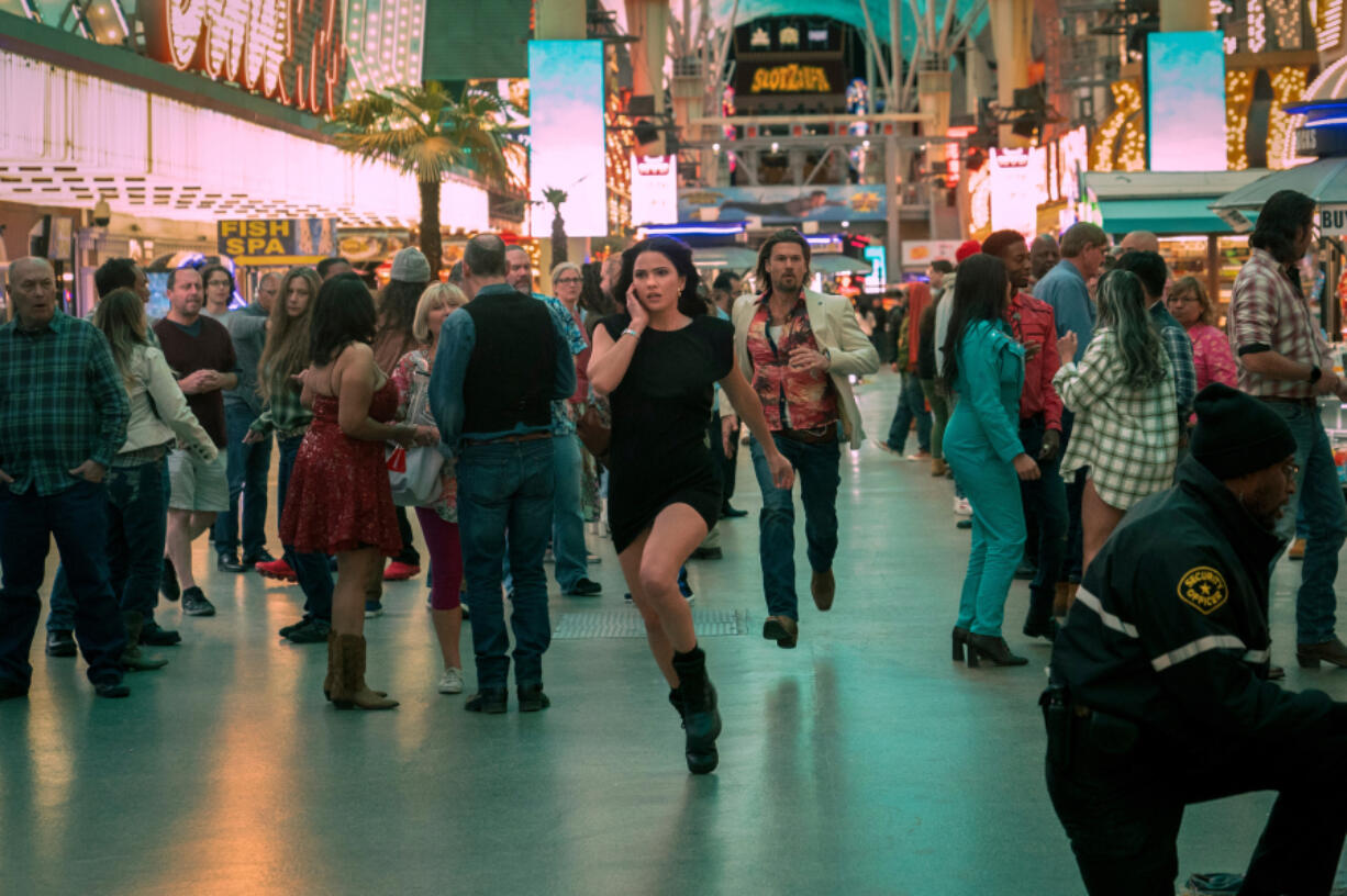 Shelley Hennig as Ava Winters and Nick Zano as Chad McKnight film a scene for &ldquo;Obliterated&rdquo; on Fremont Street. The series debuts Thursday on Netflix.