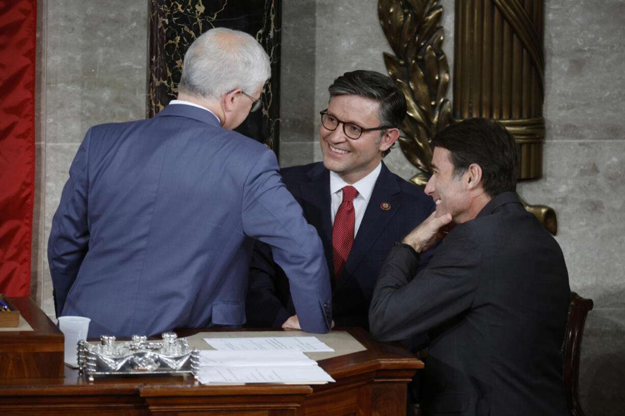 U.S. Speaker Pro Tempore Rep. Patrick McHenry (R-NC) (left), Rep. Mike Johnson (R-LA) (center) and Rep. Garret Graves (R-IA) talk as the House of Representatives holds an election for a new Speaker of the House at the U.S. Capitol on Oct. 25, 2023, in Washington, DC.