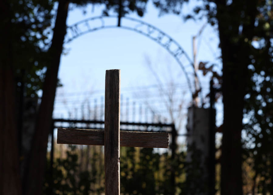 A wood cross stands in the tiny St. Mary&rsquo;s Cemetery in Des Plaines, Illinois, on Oct. 30, 2023. Among those buried in the cemetery are five Indian youths who were in a group of 41 boys from the Standing Rock Reservation brought to the school.