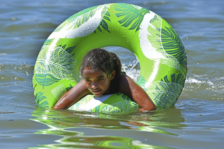 Amaya Nears, 10, of Oakley, Calif., swims in the water on Labor Day in Benicia, Calif., on Sept. 5, 2022, during an excessive heat warning as temperatures soar above 104 degrees.