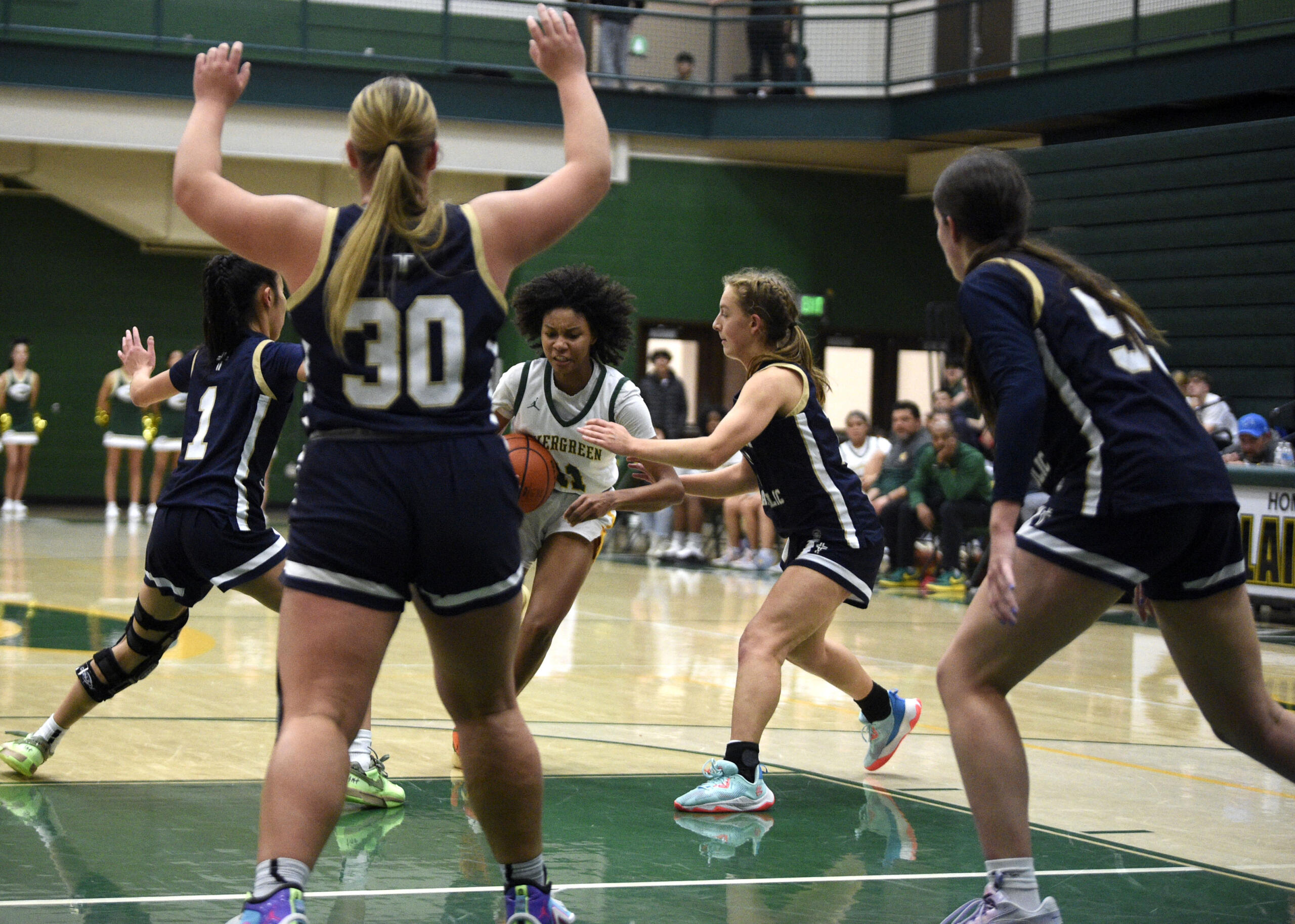 Evergreen’s Kimora Ross, center, drives into the paint as multiple Seton Catholic defenders converge during a non-league girls basketball game on Tuesday, Dec. 5, 2023, at Evergreen High School.
