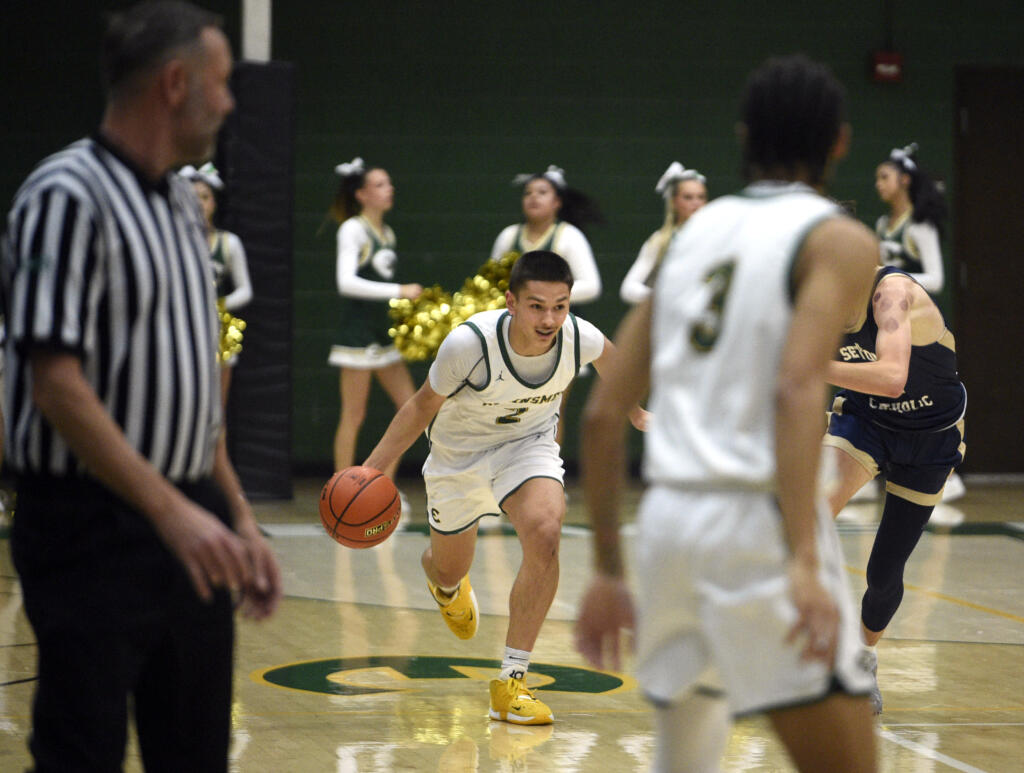 Evergreen’s Dez Daniel (2) looks to push the ball up the court in a non-league boys basketball game against Seton Catholic on Tuesday, Dec. 5, 2023, at Evergreen High School.