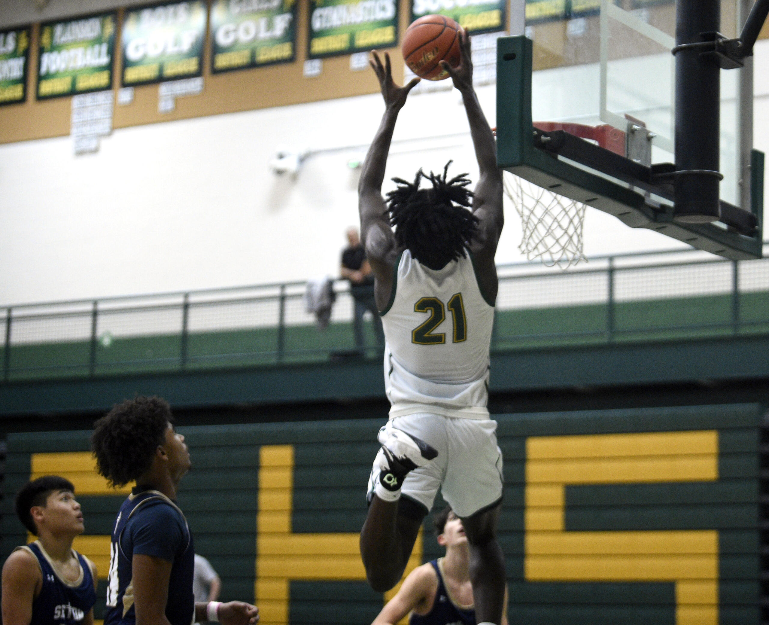 Evergreen’s Arthur Ban leaps to throw down an alley-oop dunk during a non-league boys basketball game against Seton Catholic on Tuesday, Dec. 5, 2023, at Evergreen High School.