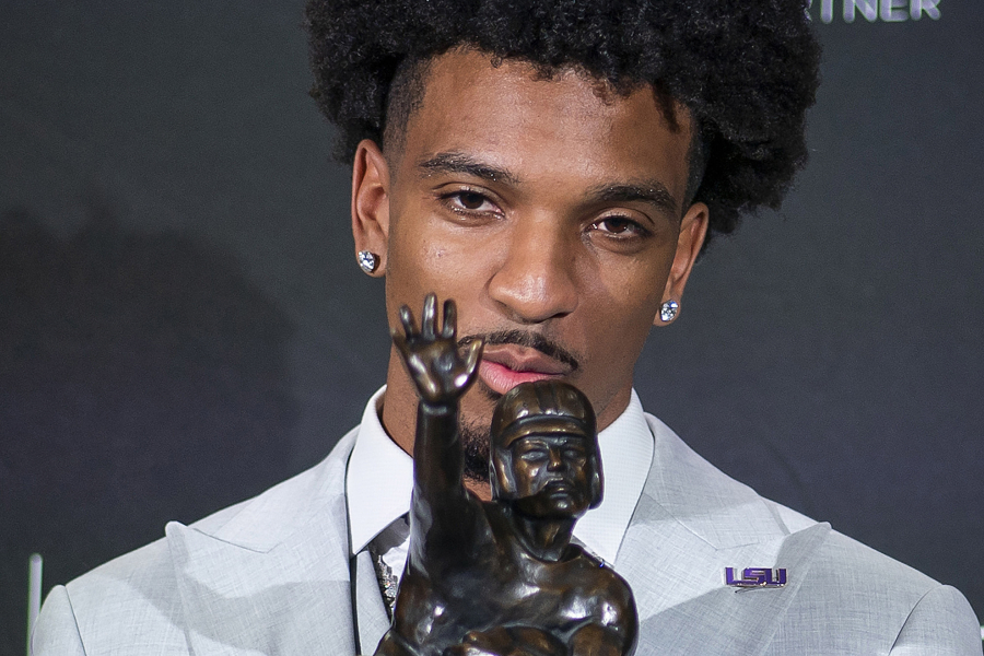 LSU quarterback Jayden Daniels kisses the Heisman Trophy during a news conference after winning the college football award, Saturday, Dec. 9, 2023, in New York.