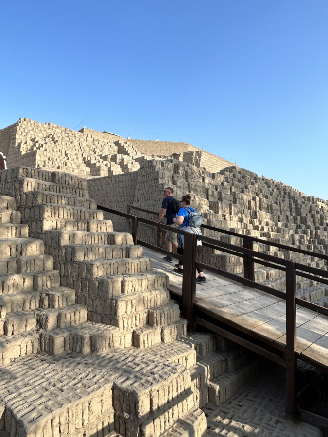Tourists hike up into ruins of an ancient structure in Lima, Peru. Walking through neighborhoods and cityscapes is one way to better understand a nation&rsquo;s culture.