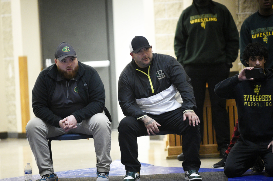 Evergreen wrestling coach Jake Wilcox (center) used his marketing skills to land a sponsor for the Pac Coast Championships and a new venue in the Clark County Event Center at the fairgrounds in Ridgefield.