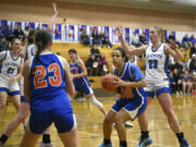 Ridgefield’s Janessa Chatman (32) looks to make a pass to a teammate during a non-league girls basketball game against La Center on Monday, Dec. 18, 2023, at La Center High School.