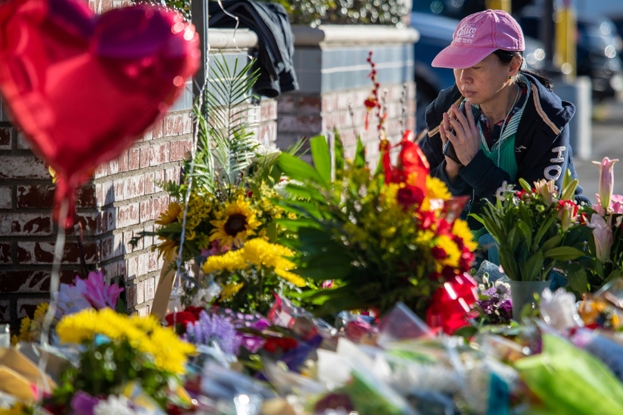 Shally, whose dance partner died in the shooting and who witnessed the shooting, pays her respects at a makeshift memorial for victims of the mass shooting outside Star Ballroom Dance Studio on Jan. 24, 2023, in Monterey Park, California.