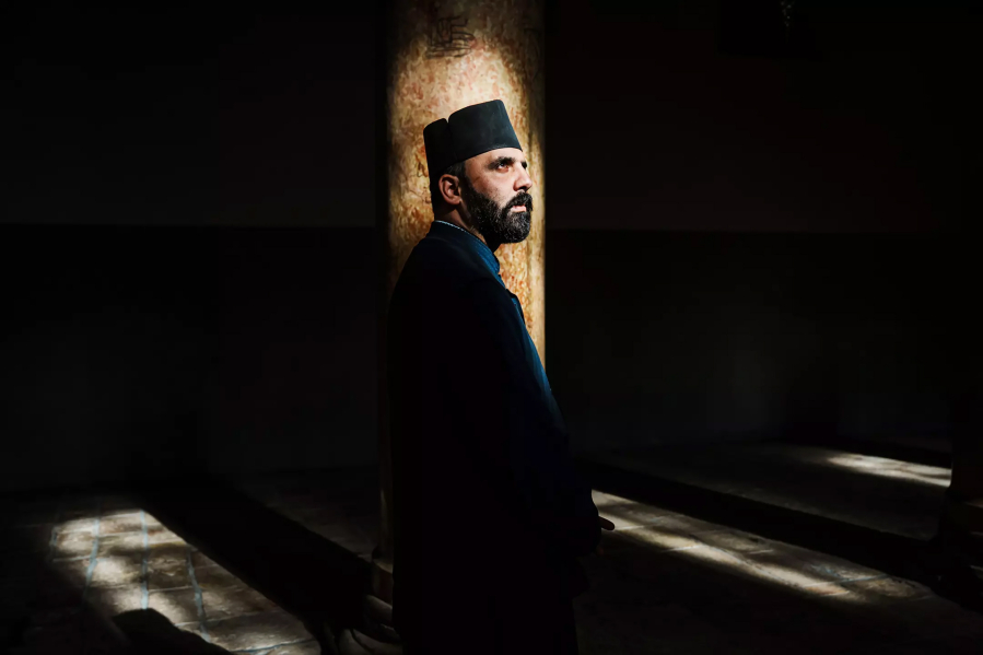 Father Issa Thaljieh poses for a portrait inside the Church of the Nativity in Bethlehem.