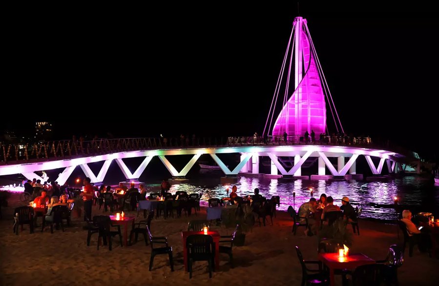People dine on the beach in the Zona Romantica district of Puerto Vallarta, Mexico.