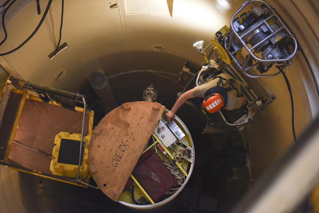 In this image provided by the U.S. Air Force, Airman 1st Class Jackson Ligon, 341st Missile Maintenance Squadron technician, examines the internals of an intercontinental ballistic missile during a simulated electronic launch Minuteman test Sept. 22, 2020, at a launch facility near Malmstrom Air Force Base in Great Falls, Mont. The Air Force has determined that cancer data recorded in health records of service members who worked with the nation's nuclear missiles warrants a further review, as part of a massive testing and cleanup effort it launched in response to reports that many who served are now ill. (Tristan Day/U.S.