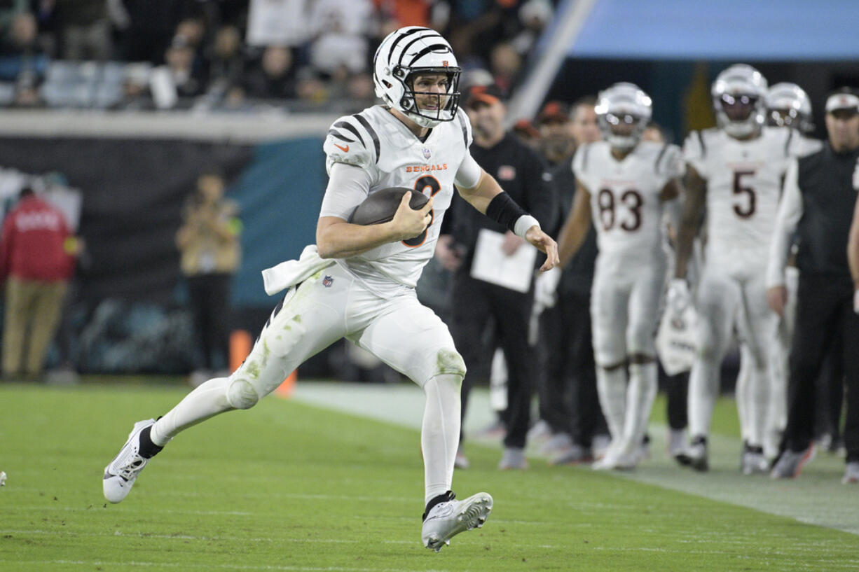 Cincinnati Bengals quarterback Jake Browning (6) runs with the football during the second half of an NFL football game against the Jacksonville Jaguars, Monday, Dec. 4, 2023, in Jacksonville, Fla. (AP Photo/Phelan M.