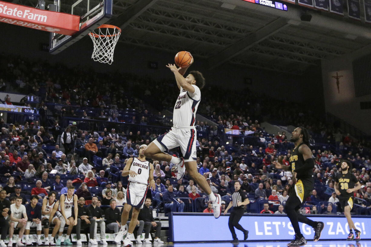 Gonzaga forward Anton Watson (22) goes up for a dunk during the second half of an NCAA college basketball game against Arkansas-Pine Bluff, Tuesday, Dec. 5, 2023, in Spokane, Wash. Gonzaga won 111-71.