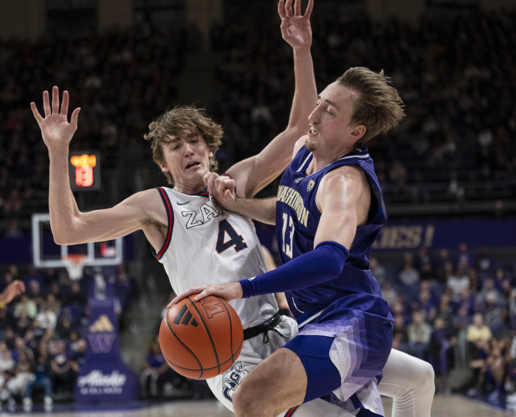 Washington's Moses Wood, right, is fouled by Gonzaga's Dusty Stromer during the first half of an NCAA college basketball game Saturday, Dec. 9, 2023, in Seattle.