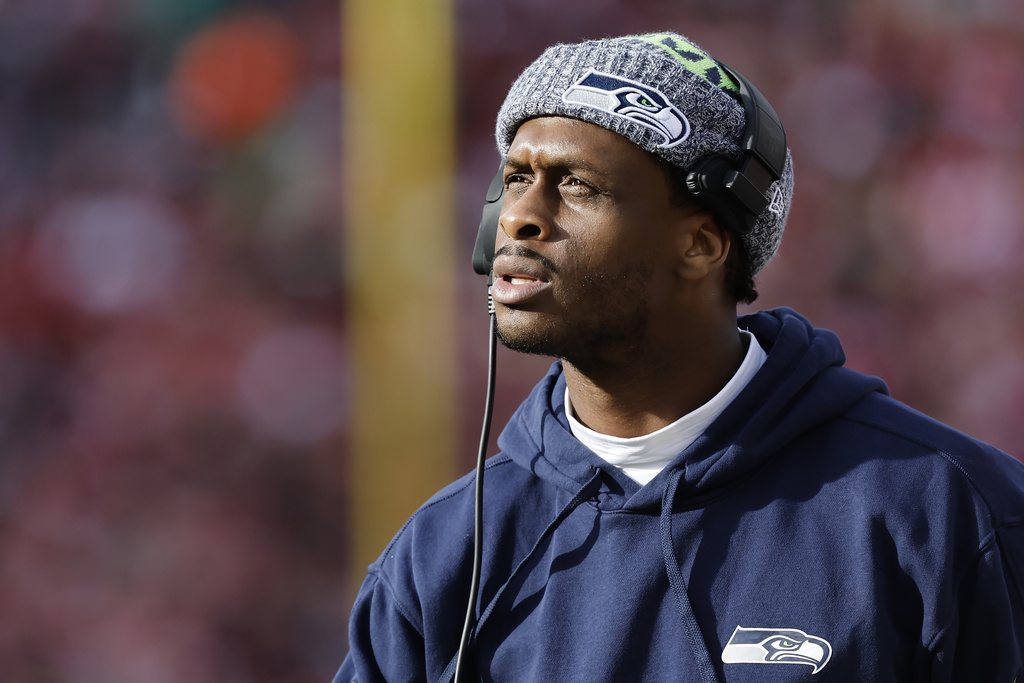 Injured Seattle Seahawks quarterback Geno Smith watches from the sidelline during the first half of an NFL football game against the San Francisco 49ers in Santa Clara, Calif., Sunday, Dec. 10, 2023.