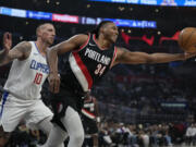 Portland Trail Blazers forward Jabari Walker (34) reaches for a rebound against LA Clippers center Daniel Theis (10) during the first half of an NBA basketball game in Los Angeles, Monday, Dec. 11, 2023.