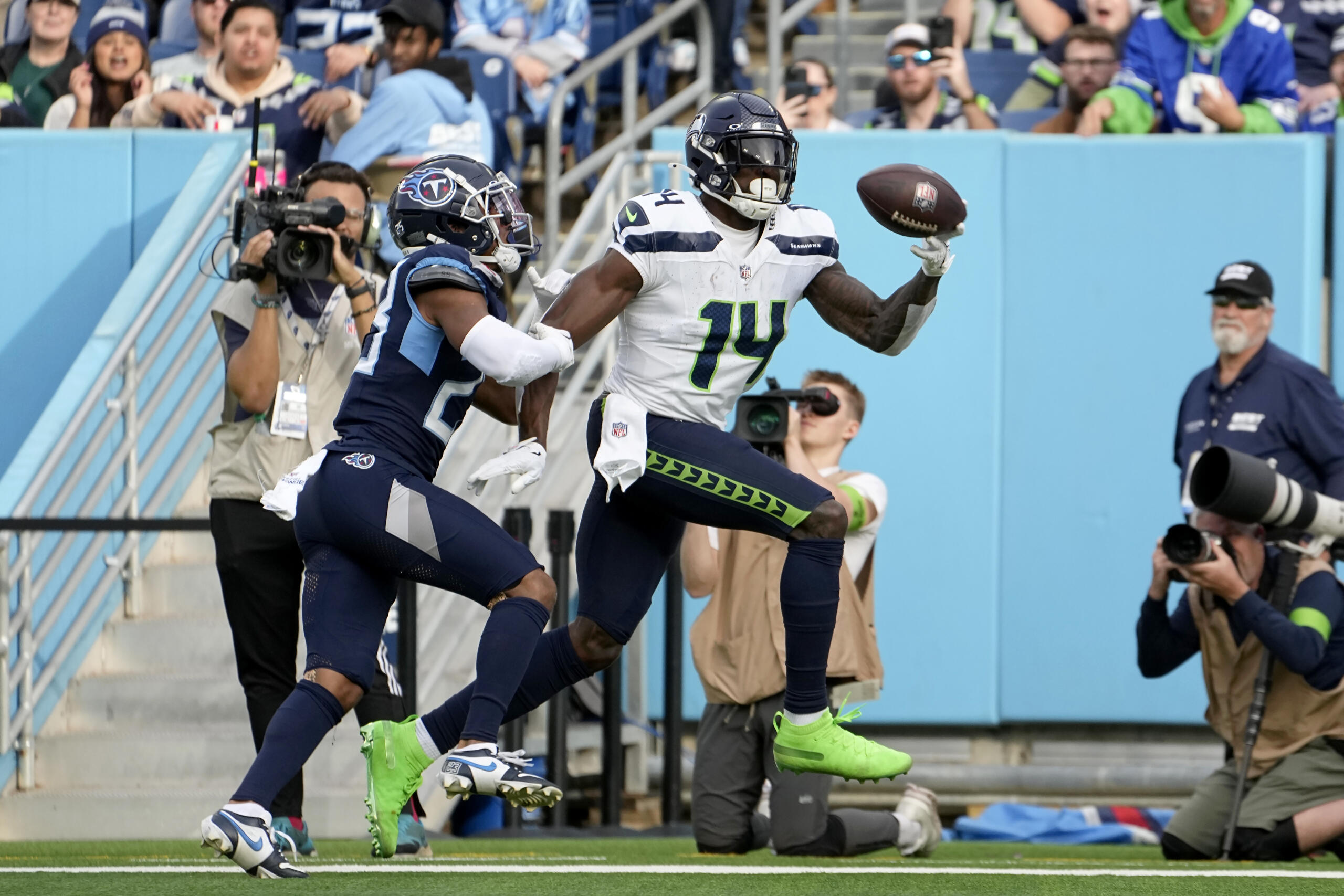 Seattle Seahawks wide receiver DK Metcalf (14) catches a touchdown pass in front of Tennessee Titans cornerback Tre Avery during the second half of an NFL football game on Sunday, Dec. 24, 2023, in Nashville, Tenn.