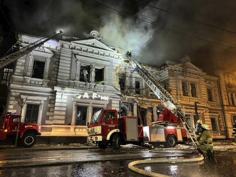 In this photo provided by the Ukrainian Emergency Service, firefighters put out a fire after a Russian missile attack in Kharkiv, Ukraine, Sunday, Dec. 31, 2023.