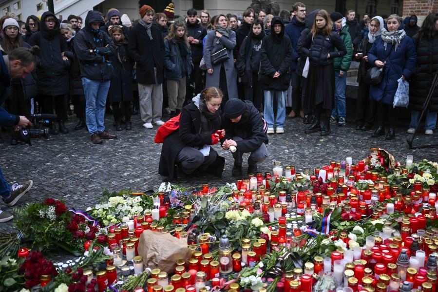 Mourners lay candle lights outside the headquarters of Charles University for victims of mass shooting in Prague, Czech Republic, Friday, Dec. 22, 2023. A lone gunman opened fire at a university on Thursday, killing more than a dozen people and injuring scores of people.