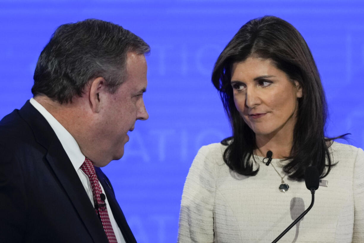 Republican presidential candidates, former New Jersey Gov. Chris Christie, left, talking with former U.N. Ambassador Nikki Haley, right, during a commercial break at a Republican presidential primary debate hosted by NewsNation on Wednesday, Dec. 6, 2023, at the Moody Music Hall at the University of Alabama in Tuscaloosa, Ala.