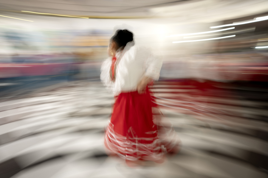 Amy Bautista Lopez, 7, wearing a traditional dress from the Mexico state of Nuevo Leon, performs during a Posada celebration, Sunday, Dec. 17, 2023, in Fort Morgan, Colo. Organizers put on the Posada, a Latin-American tradition based on the religious events of Joseph and Mary searching for shelter before the birth of Jesus, as a way for migrants in Colorado to feel a sense of unity during the holiday season.