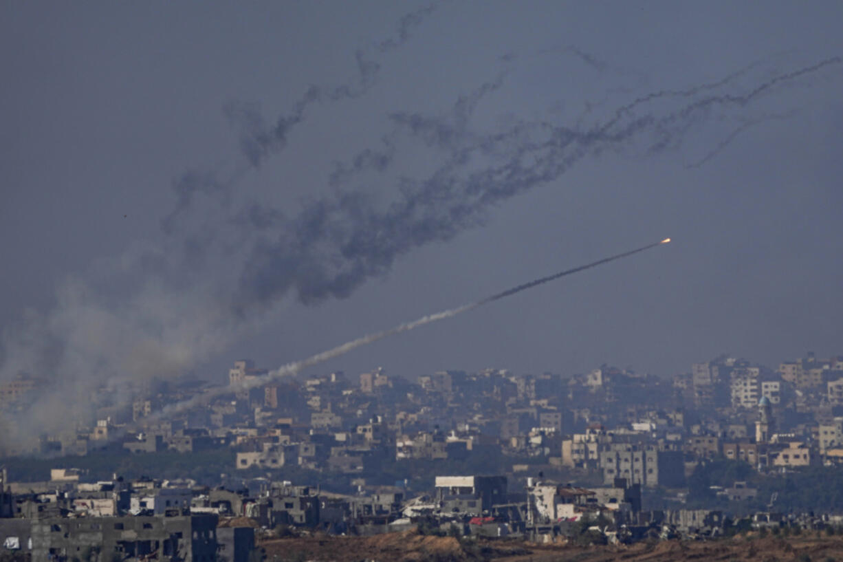 Rockets are fired toward Israel from the Gaza Strip, as seen from southern Israel, Friday, Dec. 1, 2023.