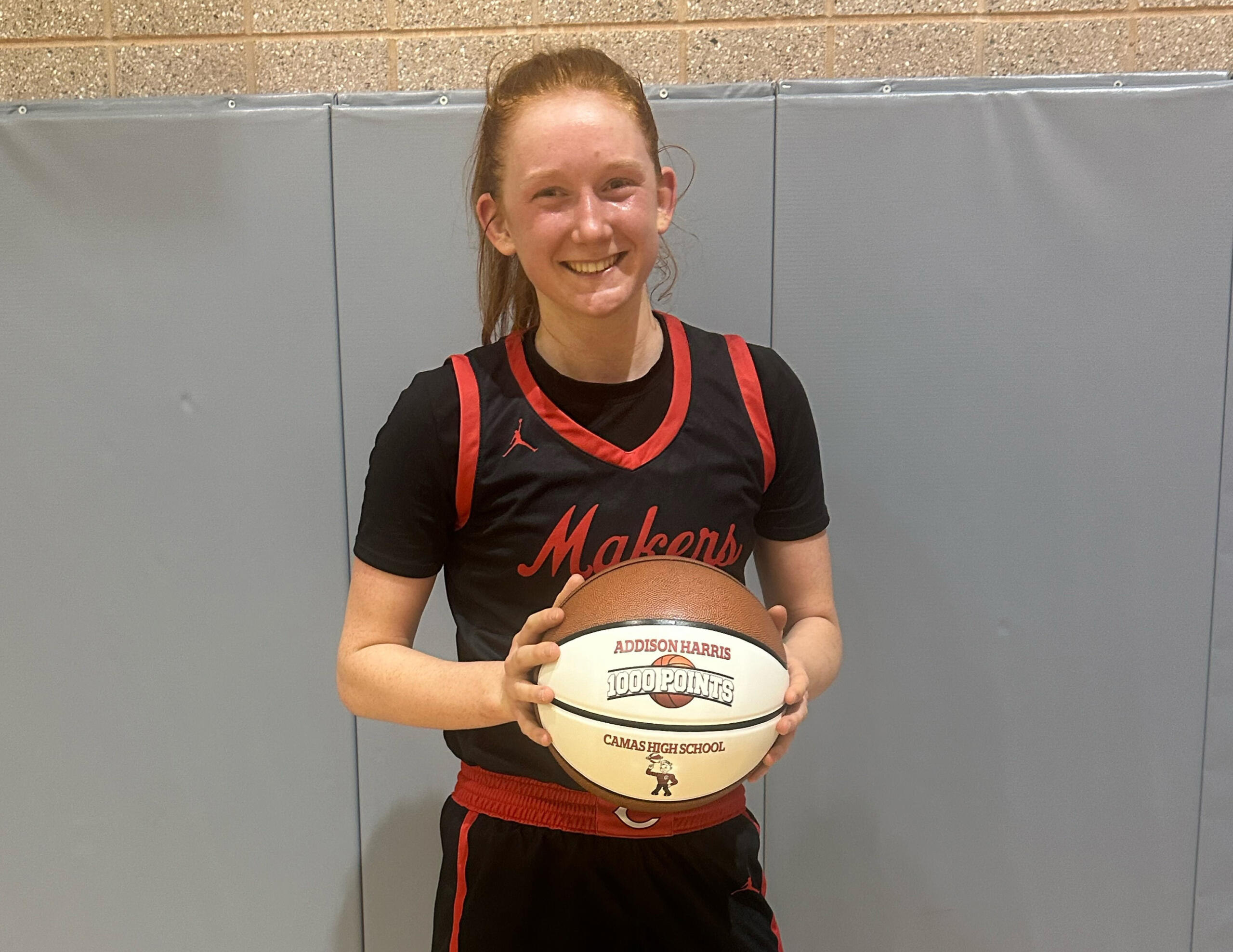 Camas senior Addison Harris holds a ball marking her 1,000th career point, scored in the Papermakers’ 51-45 win over Maret of Washington, D.C., in the Capitol Invitational on Thursday, Dec. 7, 2023 in Washington, D.C.