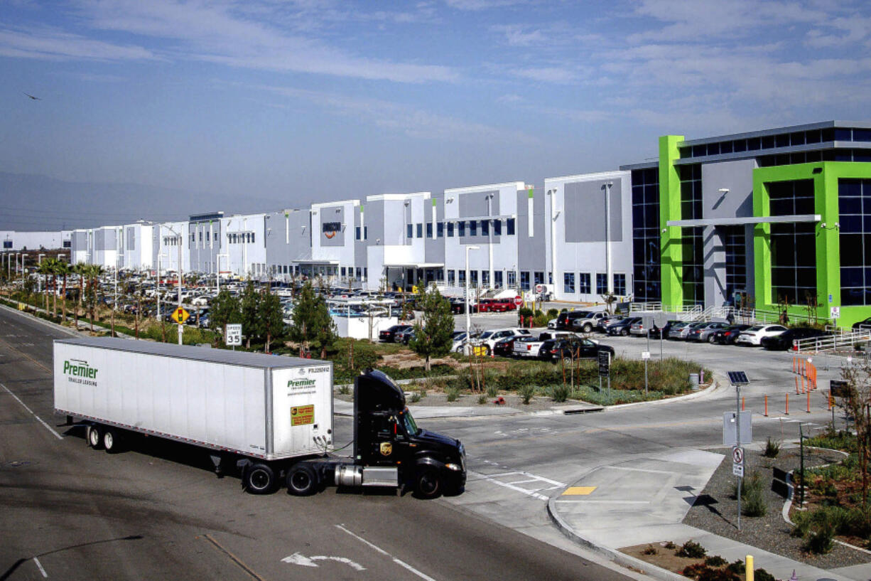 FILE - A semi-truck turns into an Amazon Fulfillment center in Eastvale, Calif. on Thursday, Nov. 12, 2020. An internal Amazon memo has provided a stark look at the company&rsquo;s carefully laid out plans to grow its influence in Southern California through a plethora of efforts that include burnishing its reputation through charity work and pushing back against &ldquo;labor agitation&rdquo; from the Teamsters and other groups.