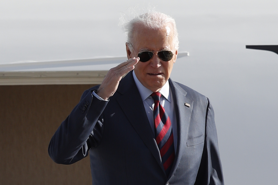 President Joe Biden returns a salute from the stairs of Air Force One, Monday, Dec. 11, 2023, at Andrews Air Force Base, Md., en route to Philadelphia. (AP Photo/Luis M.