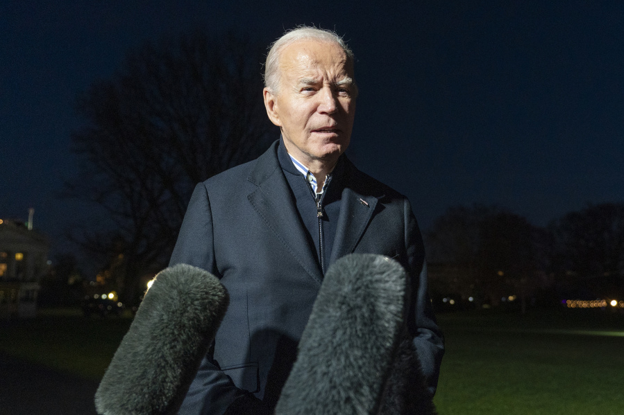 FILE - President Joe Biden answers a reporter&rsquo;s question as he walks from Marine One upon arrival on the South Lawn of the White House, Dec. 20, 2023, in Washington. Biden ordered retaliatory strikes Monday, Dec. 25, against Iranian-backed militia groups after three U.S. servicemembers were injured in a drone attack in Northern Iraq.