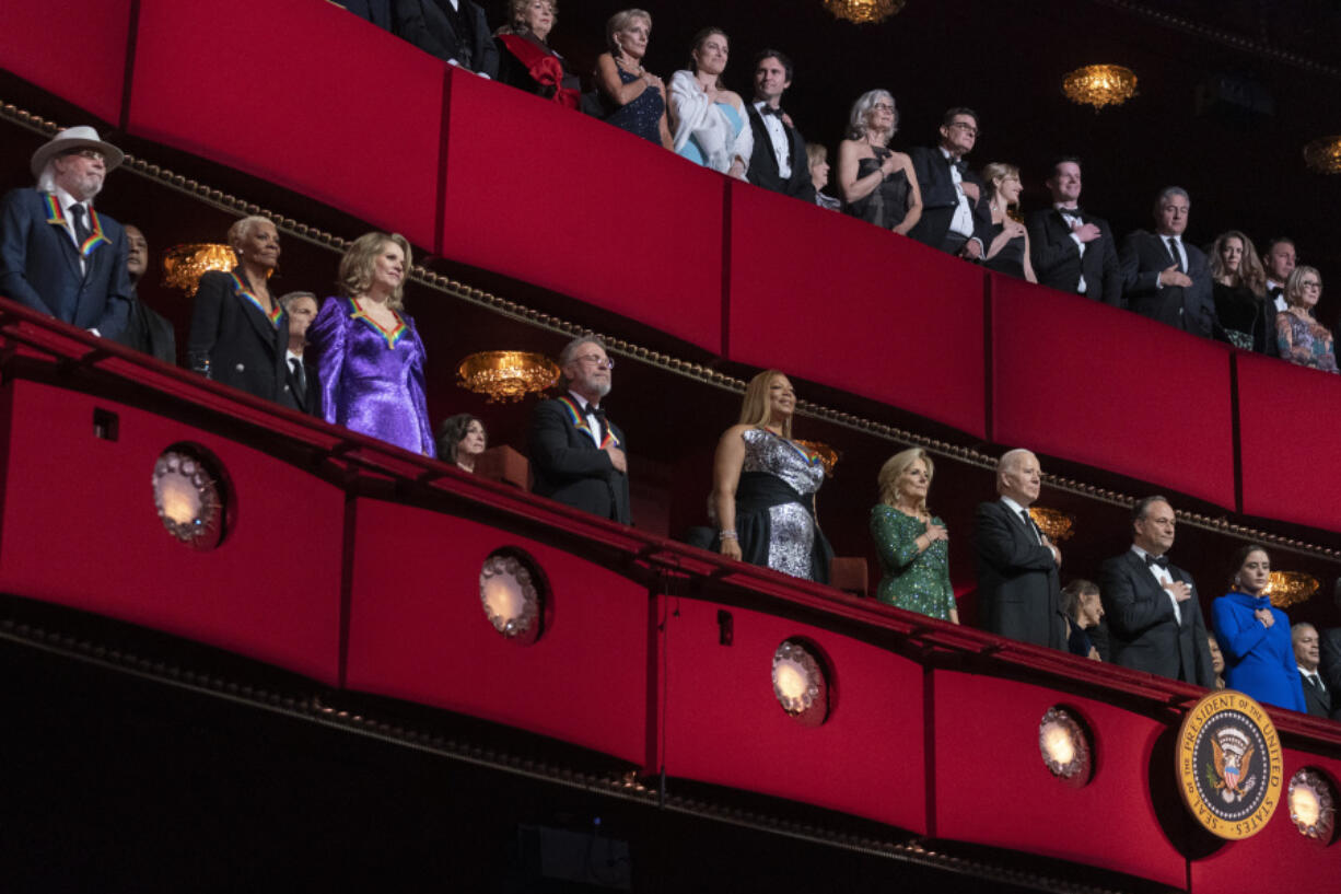President Joe Biden and first lady Jill Biden, together with 2023 Kennedy Center Honorees, from left, British singer and member of the Bee Gees, Barry Gibb; singer Dionne Warwick, soprano Ren&eacute;e Fleming, actor and comedian Billy Crystal and singer and actress Queen Latifah, attend the 46th Kennedy Center Honors at the John F. Kennedy Center for the Performing Arts in Washington, Sunday, Dec. 3, 2023.