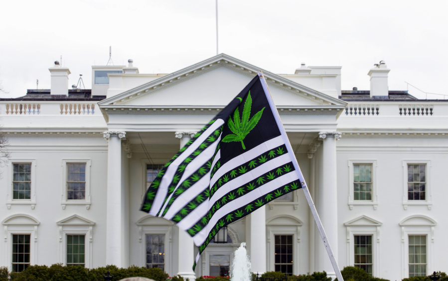 FILE - A demonstrator waves a flag with marijuana leaves depicted on it during a protest calling for the legalization of marijuana, outside of the White House on April 2, 2016, in Washington.  President Joe Biden is pardoning thousands of people who were convicted of use and simple possession of marijuana on federal lands and in the District of Columbia. The White House says his action Friday is his latest round of executive clemencies meant to rectify racial disparities in the justice system.