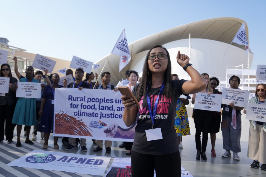 Activists demonstrate for rural people, food, land and climate justice at the COP28 U.N. Climate Summit, Wednesday, Dec. 6, 2023, in Dubai, United Arab Emirates.