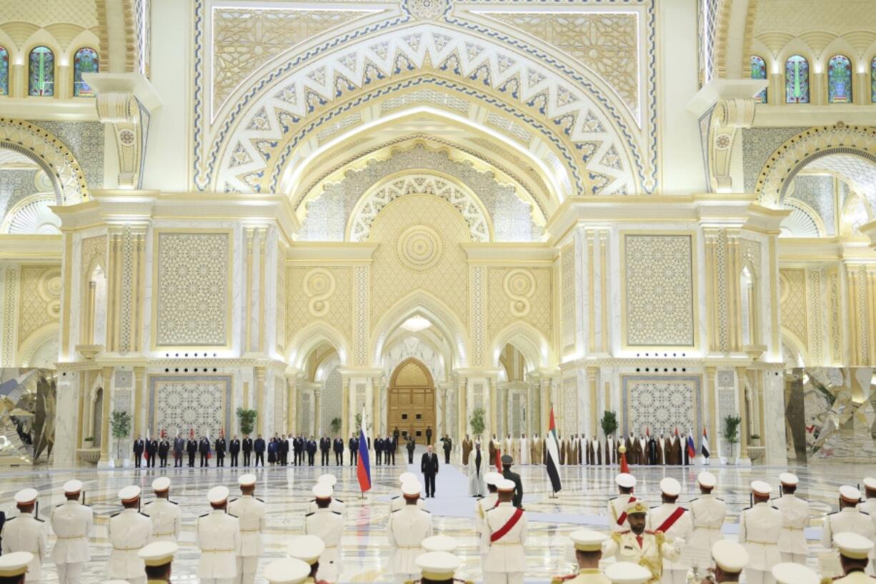 Emirati President Sheikh Mohammed bin Zayed Al Nahyan, center right, and Russian President Vladimir Putin, center left, attend an official welcome ceremony at Qasr Al Watan, Abu Dhabi, United Arab Emirates, Wednesday, Dec. 6, 2023.