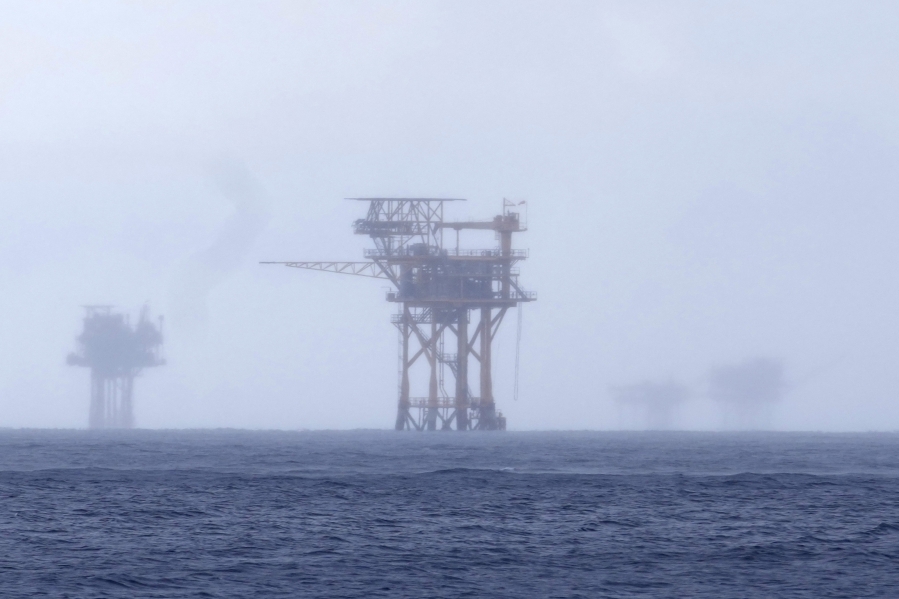 Oil platforms are visible through the haze near the Flower Garden Banks National Marine Sanctuary on Sept. 16 in the Gulf of Mexico off the coast of Galveston, Texas.