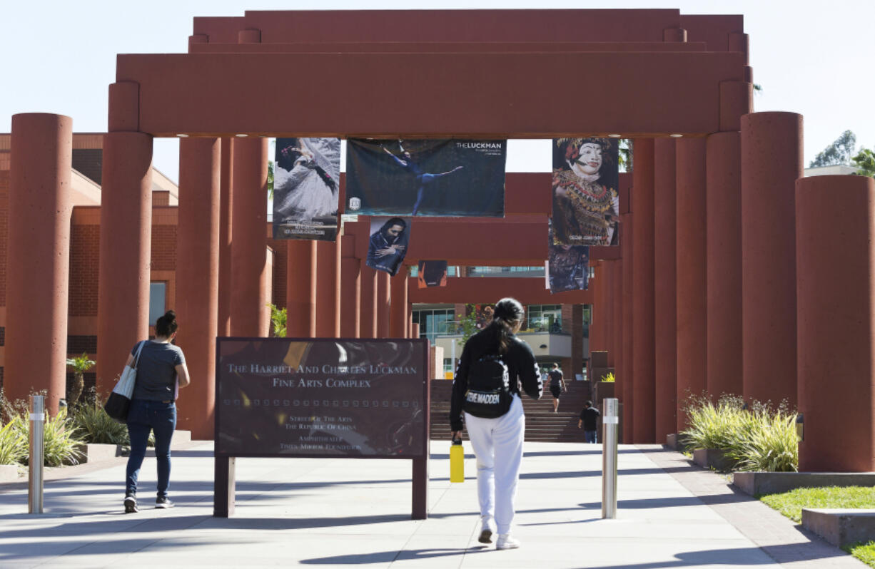 FILE - Students walk past the Harriet and Charles Luckman Fine Arts Complex at the California State University, Los Angeles campus, April 25, 2019. Faculty at California State University, the largest public university system in the U.S., will hold a series of four one-day strikes starting Monday, Dec. 4, 2023, across four campuses to demand higher pay and more parental leave for thousands of professors, librarians, coaches and other workers.
