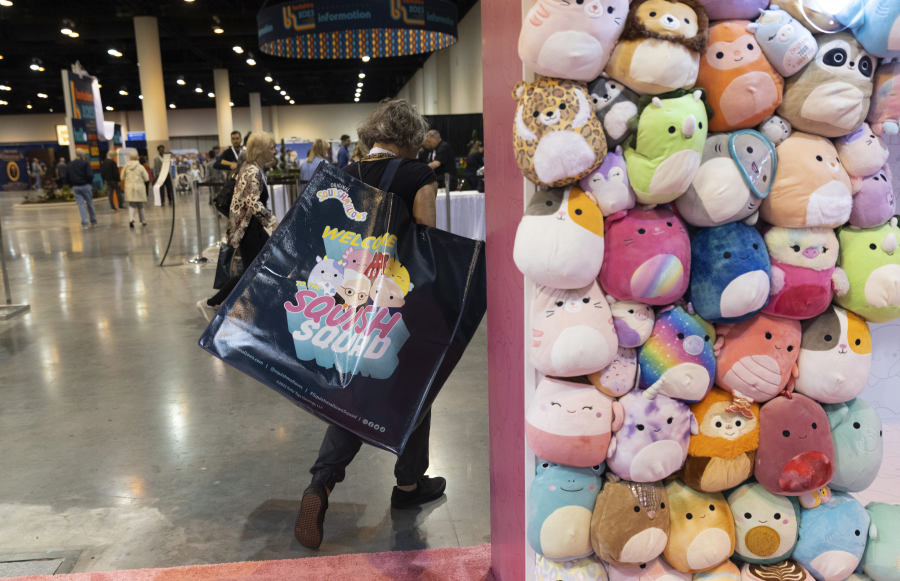 FILE - A shareholder leaves the Squishmallows booth with a large bag of purchases in the exhibition hall of the Berkshire Hathaway annual meeting on Saturday, May 6, 2023, in Omaha, Neb. A judge in New York has ruled that Alibaba must face a lawsuit by a U.S. toymaker alleging that the Chinese ecommerce giant&rsquo;s online platforms were used to sell counterfeit Squishmallows.  (AP Photo/Rebecca S.