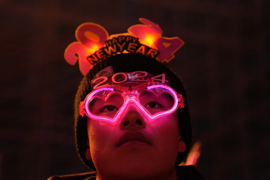 A reveler wears neon spectacles to ring in the new year in Beijing, Sunday, Dec. 31, 2023.