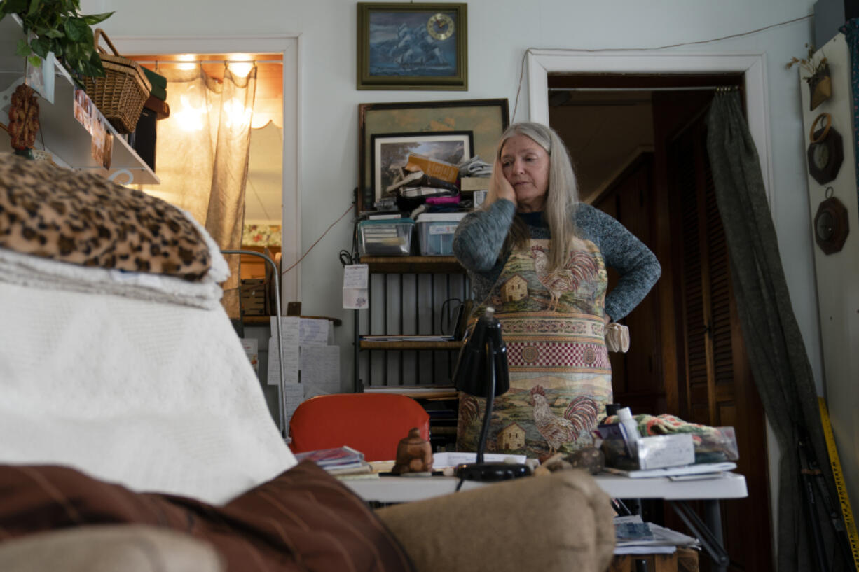 FILE - Nancy Rose, who contracted COVID-19 in 2021 and exhibits long-haul symptoms including brain fog and memory difficulties, pauses while organizing her desk space, Tuesday, Jan. 25, 2022, in Port Jefferson, N.Y. Rose, 67, said many of her symptoms waned after she got vaccinated, though she still has bouts of fatigue and memory loss. U.S. health officials estimate 3.3 million Americans have chronic fatigue syndrome &mdash; a bigger number than previous studies have suggested, and one likely boosted by patients with long COVID, according to results released by the Centers for Disease Control and Prevention on Friday, Dec. 8, 2023.