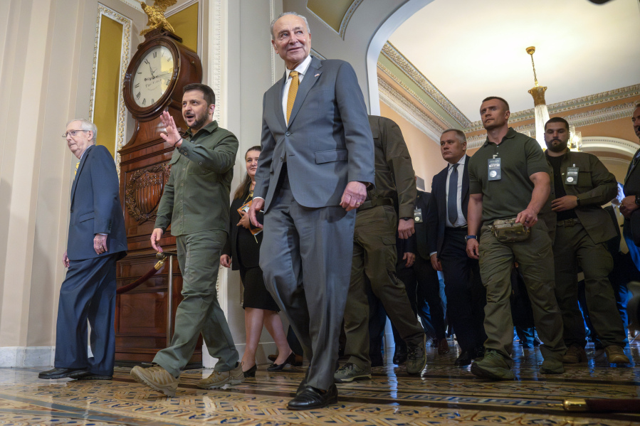 FILE - Ukrainian President Volodymyr Zelenskyy, second from left, walks with Senate Minority Leader Mitch McConnell of Ky., left, and Senate Majority Leader Chuck Schumer of N.Y., right, at Capitol Hill on Thursday, Sept. 21, 2023, in Washington. Congress broke for the holidays, not expected to return for two weeks while continued aid for Ukraine has nearly been exhausted.