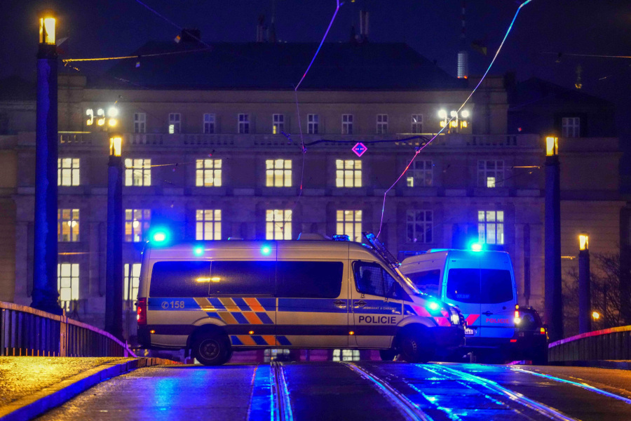 Police officers in a van secure the area in downtown Prague, Czech Republic, Thursday, Dec. 21, 2023. Czech police say a shooting in downtown Prague has killed an unspecified number of people and wounded others.